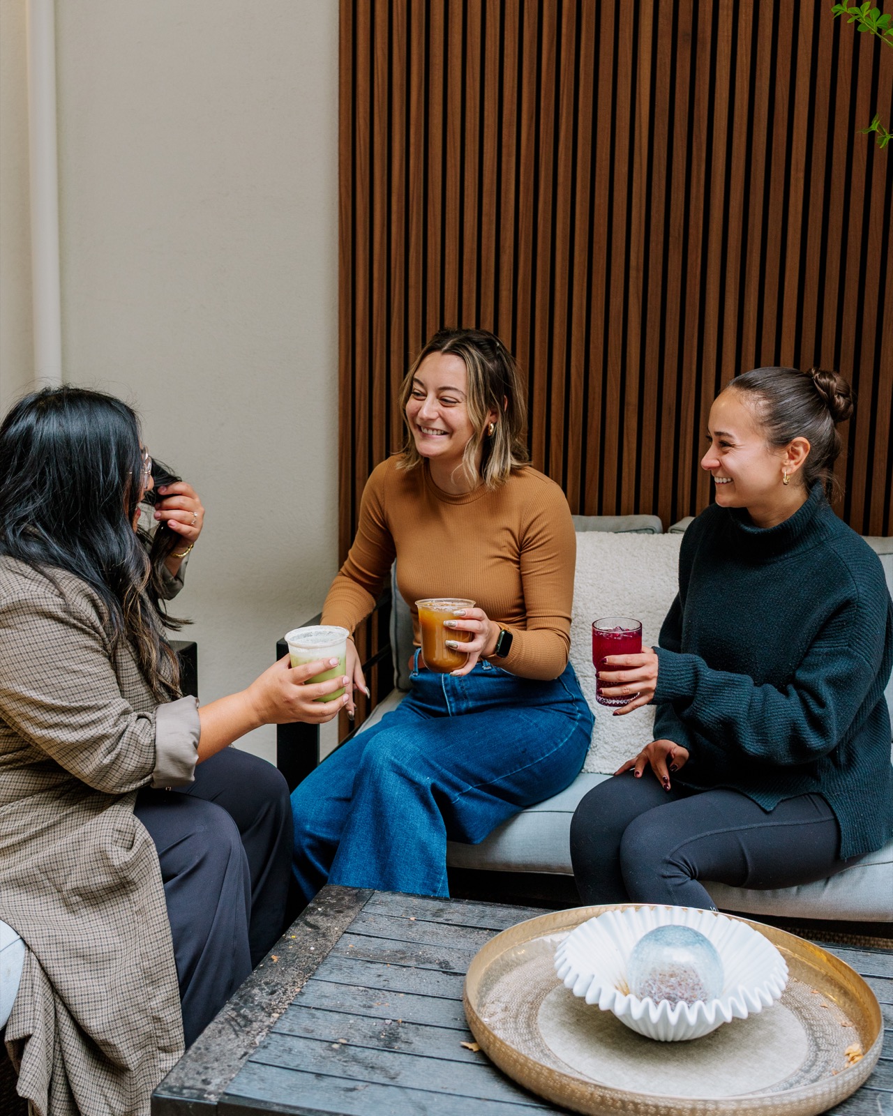 Friends sharing drinks at the Rising For People café in Reno